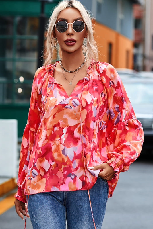 Blusa de manga larga con lazo y borlas florales