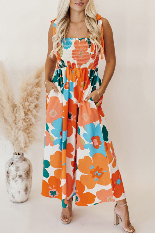 Robe longue orange à fleurs et bretelles nouées au buste smocké