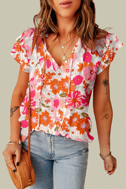 Blusa con mangas abullonadas y cuello con lazo floral